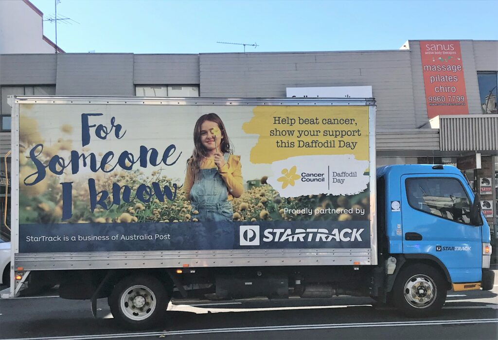 Using fleet graphics for good. StartTrack, a division of Australia Post, magnifies their support for the Cancer Council's Daffodil Day by broadcasting this message using their core fleet.